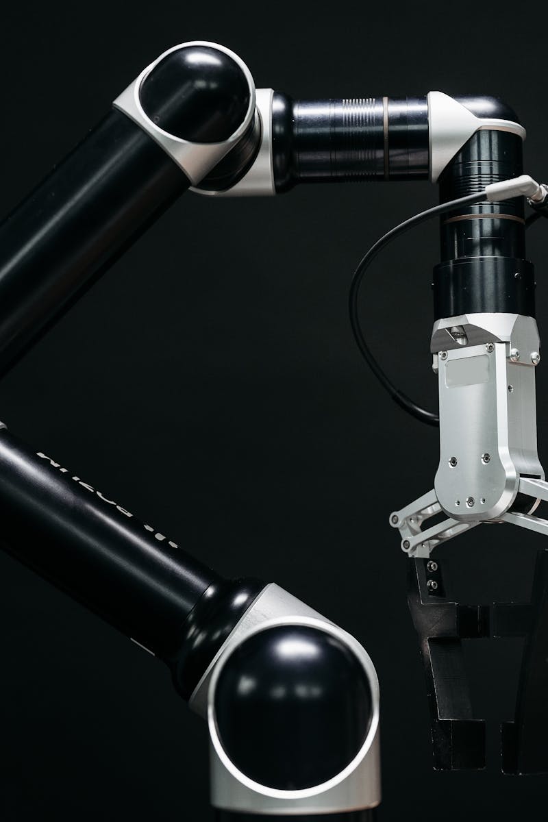 Close-up of a mechanical robotic arm with a dark background, showcasing advanced technology.